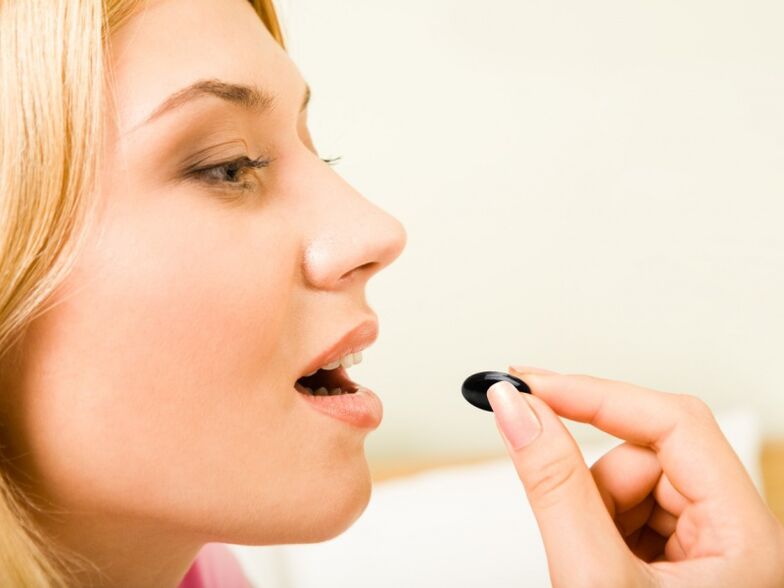 Girl takes a pill to prevent worms